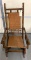 Antique spindle platform rocker with woven seat/back