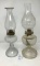 Two clear glass oil lamps