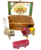 Pig and lion cast iron bank, cast circus train car and Canones cigarbox