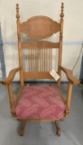 Antique rocking glider with upholstered seat