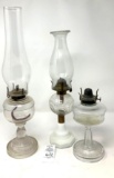 Three oil lamps one missing chimney