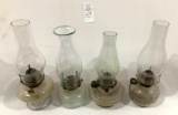 Four clear glass oil lamps