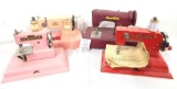 Four miniature vintage sewing machines