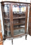 Walnut flat topped curved glass China cabinet