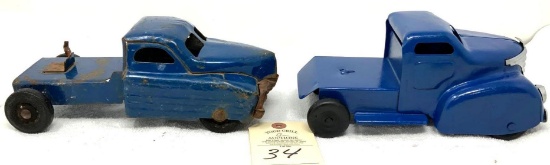 Two antique blue pressed steel trucks