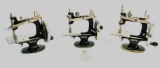 Three vintage child size metal singer hand crank sewing machines