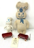 Two vintage Pillsberry doughboys and two toy wagons