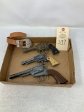 Three vintage toy guns and one belt