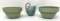 Two green antique crock bowls and a creamer