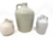 Three white antique crock jugs