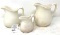 Three white antique pitchers