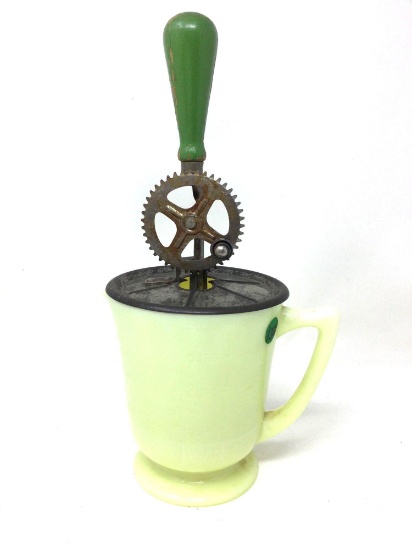Antique yellow milk glass beater jar with green handle