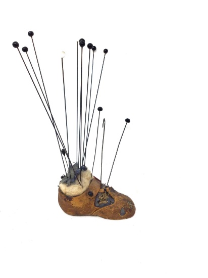 Antique shoe with hat pins