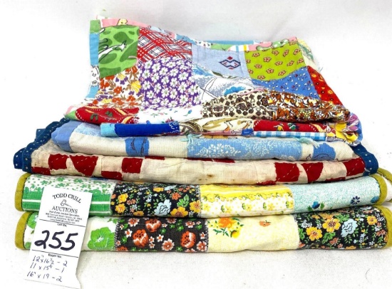 Five small quilted doll blankets