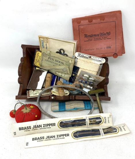 Vintage wooden box with symbols, pin cushions, and misc. buttons