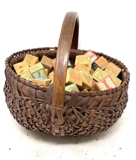 Vintage woven basket with children"s wooden blocks