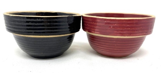 Two antique USA black and cranberry crock bowls
