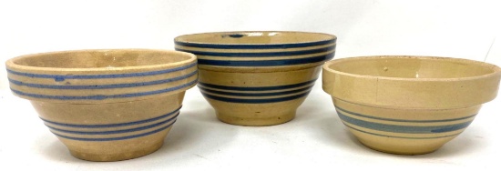 Three antique crock bowls with blue lines