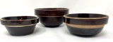 Three antique brown crock bowls