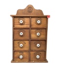 Vintage wooden spice cabinet with eight drawers and porcelain handles