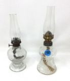 Two antique clear glass finger lamps