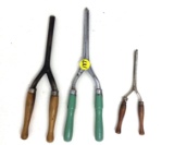 Three antique wooden handled curling irons