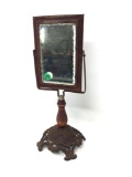 Antique mirror with a cast iron base