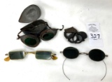 Antique safety goggles in a metal case, two pair of vintage sunglasses and eye Ioop