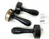 Three vintage black sock darners, one with metal ring