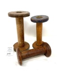 Three antique wooden yarn spools