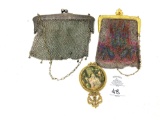 Two antique metal clutches and a hand mirror