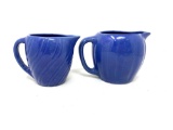 Two vintage USA blue pitchers