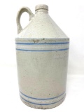 Antique white crock jug with blue and white lines