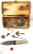 Wooden box with knife, belt buckles, and assorted items