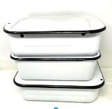 Three black and white enamel ware pans with lids