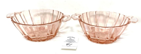Two vintage pink depression handled candy dishes