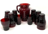 Vintage red pitcher and fifteen glasses