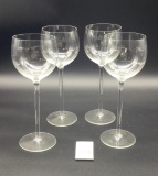 Four long stem wine glasses