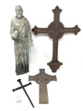 Antique metal crosses and resin statue