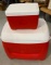 Red Igloo coolers with handle and wheels on large one