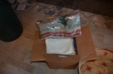 Box of Linens and blankets with wicker basket