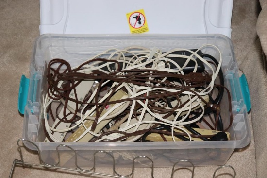 Tote full of extension cords and surge protectors, and a shoe rack