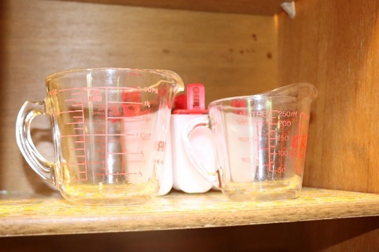 Contents of Cabinet including Pyrex Measuring cups, Tupperware measuring bowls etc.