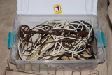 Tote full of extension cords and surge protectors, and a shoe rack