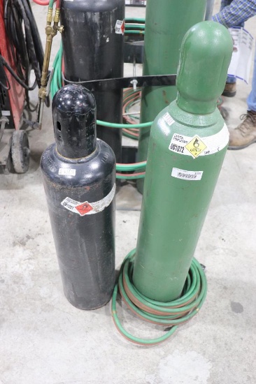 OXYGEN AND ACETYLENE TANKS AND ROLL OF HOSE