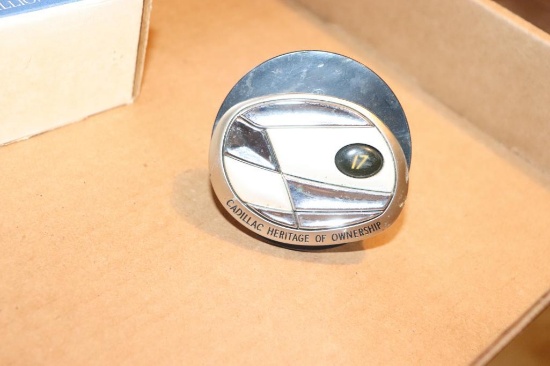Various years of Cadillac wheel medallions