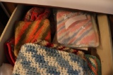 Contents of drawer including hot pads and oven mits
