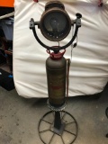 5' Tall C M Hall Lamp Co. Model Solar. Mounted on brass fire extinguisher, on top of a machine tool.
