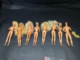 Seven Barbie dolls and one Ken