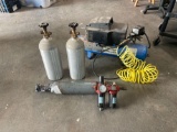 Assortment of air tanks pressure gauge and compressor